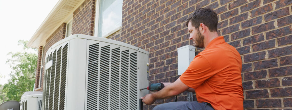 Skelton’s HVAC Technician Repairing Outdoor AC Unit Skelton’s HVAC technician repairing an outdoor air conditioning unit at a Birmingham Alabama home